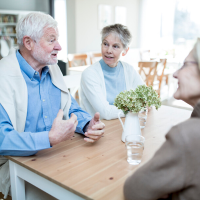 senior caregivers talking at table in the kitchen