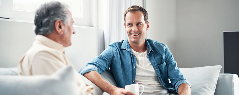 young man talking with senior father